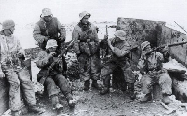 Escuadra de infantería alemana comprobando sus armas antes de una patrulla. Invierno de 1942-1943